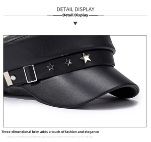 Detail of black PU leather flat top cap with metallic star rivets and textured finish
