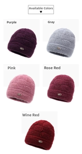 Detail view of five assorted color knitted hats with checkered patterns and metal ornaments