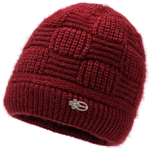 Close-up of wine red knitted hat with textured grid pattern and floral metal ornament