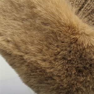 Detailed close-up of brown faux fur lining and dense knit texture on a winter hat