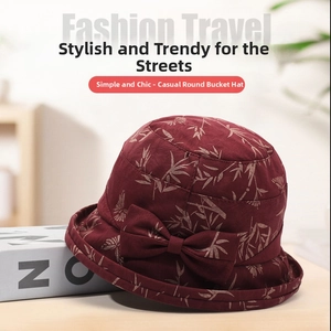 Detail of burgundy cloche hat with bamboo leaf prints and a stylish side bow accessory