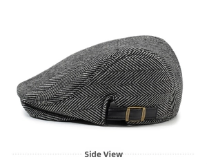 Detail view of grey herringbone beret featuring a leather strap with brass metal buckle