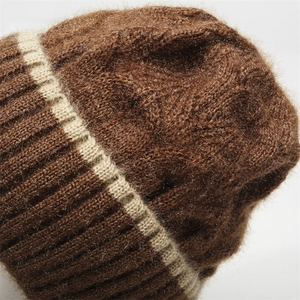 Close-up of dark brown knit hat showing soft mohair texture and beige stripe detail