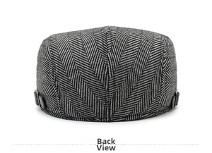 Detailed back view of a grey herringbone flat cap with leather strap and metal buckle