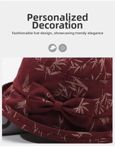 Detail of dark red cloche hat featuring golden leaf print and fabric bow decoration