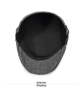 Detailed macro view of gray herringbone newsboy hat with soft fleece lining and sweatband