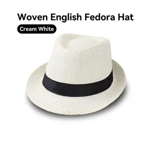Close-up of cream white straw fedora hat featuring a classic black ribbon decorative band