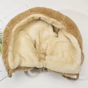 Detail view of thickened winter hat with warm camel faux fur and soft fleece lining