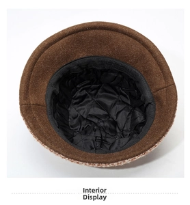 Detail view of the brown winter hat showing black quilted lining and sweatband inside