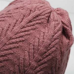 Macro shot of bean paste pink knitted wool fabric with elegant leaf texture pattern
