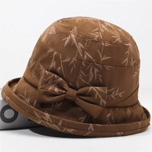 Deep brown bucket hat for women with bamboo leaf print and an elegant side bow decoration