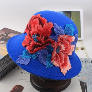 Detail showing colorful floral embroidery on navy blue wool cloche bucket hat for women
