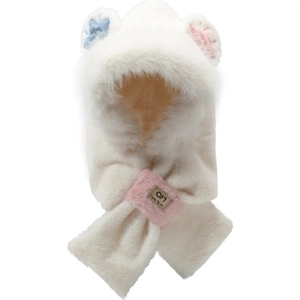 Detailed view of plush white bear hat featuring cute blue paw print and pink ear accents