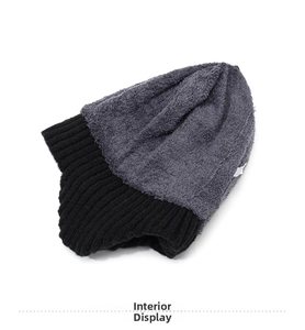 Close-up of winter knit hat featuring thick black knit and warm grey fleece lining interior