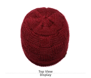 Top-down view of thick dark red knit beanie with textured block pattern for women