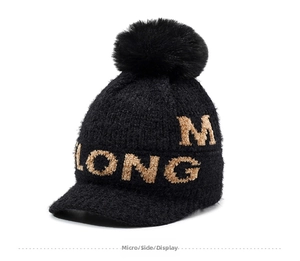 Detailed side view of black chenille knit beanie with fluffy pom-pom and letter embroidery