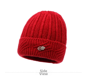 Detail of red knitted winter hat featuring a silver flower rhinestone brooch