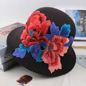 Close-up of intricate floral embroidery on black wool felt fedora with detailed stitching