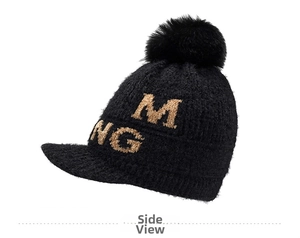 Detail of black chenille knit beanie with pom-pom, visor and embroidered letter logo