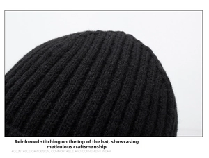 Detailed close-up showing reinforced stitching and fine ribbed texture on a black knit beanie