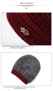 Detail of burgundy knitted hat with rhinestone ornament and thick gray fleece lining