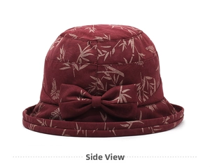 Detail of dark red bucket hat with bamboo leaf print and large bow ornament