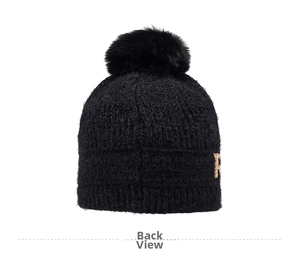Detail view of the soft chenille knit texture and fluffy pom-pom on this black winter hat