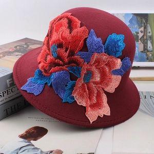 Close-up of intricate floral embroidery on a burgundy wool cloche hat for women