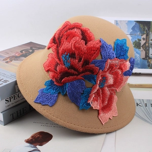 Close-up of intricate 3D floral embroidery on camel wool cloche hat for women