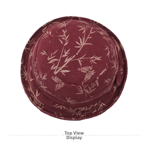 Top view of deep red bucket hat with bamboo leaf and butterfly prints and ribbon bow