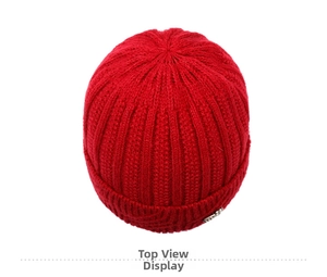 Top view of red winter knitted hat for elderly women with warm fleece lining and metal detail