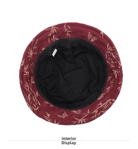 Interior view of the burgundy cloche hat showing black lining and printed gold patterns