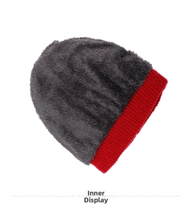 Close-up of thick grey fleece lining and red ribbed knit edge on winter thermal hat