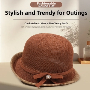 Detail of breathable knit sun hat with elegant brown bow and centered pearl accent