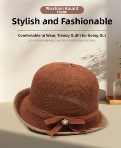 Close-up of knit sun hat with pearl bow detail and elegant contrasting brim texture