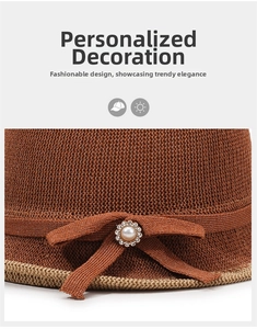 Detail of knitted sun hat featuring a brown bow with a pearl and rhinestone flower
