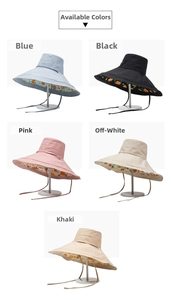 Detail view of double-sided sun hats with vibrant fruit prints and adjustable wind straps