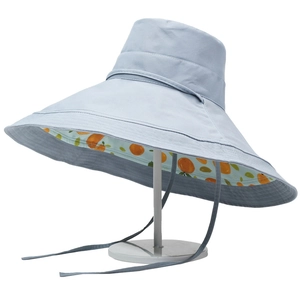 Wide brim sun hat with citrus print lining and chin strap on a white stand
