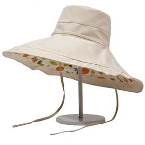 Wide brim sun hat with reversible orange print and adjustable chin strap in beige