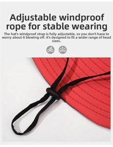 Detail of adjustable windproof chin strap on red sun hat for secure outdoor fit