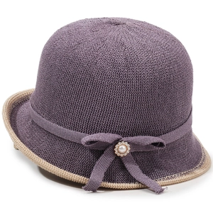 Purple breathable knitted bucket hat with a bow and pearl accent on a plain white background