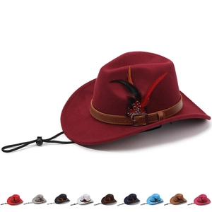 Detail of burgundy wool felt cowboy hat with leather band, feather and wind rope