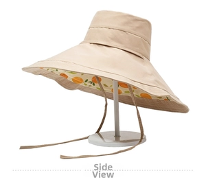 Detail view of large brim sun hat featuring orange citrus print lining and chin strap