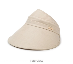 Detail of beige sun visor hat showing breathable linen texture and gold metal logo accent