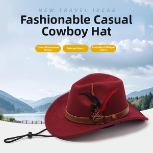 Detail of red felt cowboy hat with leather band, buckle, and feather trim against mountains