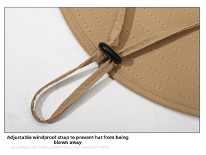 Detail of adjustable windproof drawstring and khaki fabric texture on outdoor sun hat