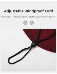 Detail of adjustable black elastic chin strap and toggle on a burgundy felt cowboy hat