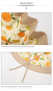 Detail view of the reversible sun hat's inner adjustable drawstring and fruit print pattern
