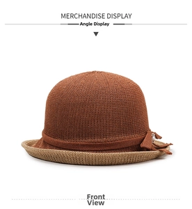 Detail of knitted bucket hat with contrast beige brim and elegant pearl bow accent