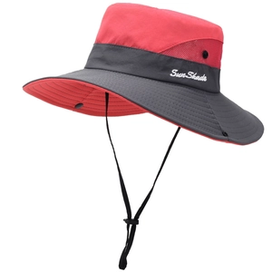 Detail view of red sun hat featuring breathable mesh side panels and adjustable chin strap